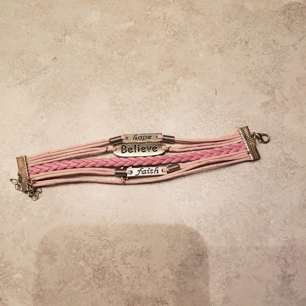 Pink cord and silver breast cancer bracelet with inspirational charms.